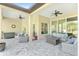 Inviting covered patio with multiple seating areas perfect for outdoor entertaining and relaxation at 5034 Nw 75Th Ave, Ocala, FL 34482