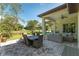 Expansive patio with a dining table and wicker sofas overlooking a lush green field and trees at 5034 Nw 75Th Ave, Ocala, FL 34482
