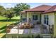 Inviting outdoor patio with comfortable seating, dining area, and scenic views of the well-maintained backyard at 5034 Nw 75Th Ave, Ocala, FL 34482