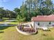 Side exterior of a stucco home with a paved driveway and manicured landscaping at 5034 Nw 75Th Ave, Ocala, FL 34482