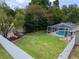 Aerial view of spacious backyard with a screened-in pool and a lush lawn at 5390 Se 15Th Ct, Ocala, FL 34480