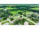 Gorgeous aerial view of the community with verdant fields and meticulously maintained lawns at 5390 Se 15Th Ct, Ocala, FL 34480
