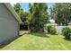 Spacious backyard with green grass, pergola, and mature trees at 5390 Se 15Th Ct, Ocala, FL 34480