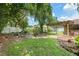 Spacious backyard with mature trees, a patio area, and fenced perimeter at 5390 Se 15Th Ct, Ocala, FL 34480