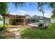 Backyard features a screened pool, outdoor bar, and stone pathway at 5390 Se 15Th Ct, Ocala, FL 34480