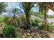 Backyard features a pond and lush landscaping at 5390 Se 15Th Ct, Ocala, FL 34480