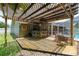 Backyard bar with a pergola, bar seating, and deck at 5390 Se 15Th Ct, Ocala, FL 34480