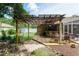 Backyard bar area with a pergola and outdoor seating at 5390 Se 15Th Ct, Ocala, FL 34480