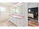 Bright bathroom featuring dual sinks, a large mirror, and seamless bedroom access at 5390 Se 15Th Ct, Ocala, FL 34480