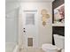 Bright bathroom with a tub/shower, stylish decor, and exterior access at 5390 Se 15Th Ct, Ocala, FL 34480