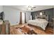 Spacious bedroom featuring hardwood floors, a statement wall, and natural lighting at 5390 Se 15Th Ct, Ocala, FL 34480