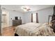 Relaxing bedroom with wood floors, dresser, and large window for natural light at 5390 Se 15Th Ct, Ocala, FL 34480
