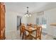 Bright dining room with a wooden table set, chandelier lighting, and access to the patio at 5390 Se 15Th Ct, Ocala, FL 34480