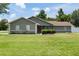 Beautifully maintained single-story home with a lush green lawn and meticulously landscaped front yard, creating inviting curb appeal at 5390 Se 15Th Ct, Ocala, FL 34480