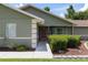Inviting front entrance featuring a charming door, manicured landscaping, and a neatly maintained walkway, creating a warm welcome at 5390 Se 15Th Ct, Ocala, FL 34480