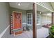 Charming covered front porch featuring a decorative welcome sign, seasonal decor, and stylish accents, creating a warm invitation at 5390 Se 15Th Ct, Ocala, FL 34480