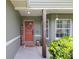 Cozy front porch with decorative accents, a welcoming welcome sign, and charming curb appeal, creating a warm and inviting entrance at 5390 Se 15Th Ct, Ocala, FL 34480