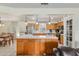 Charming kitchen featuring wood cabinets, stainless steel appliances, and a breakfast bar with a tile countertop at 5390 Se 15Th Ct, Ocala, FL 34480