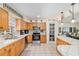 Bright kitchen with wood cabinets, stainless steel appliances, and an adjacent living area at 5390 Se 15Th Ct, Ocala, FL 34480