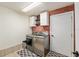 Laundry room with brick accent wall and modern appliances at 5390 Se 15Th Ct, Ocala, FL 34480