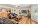 Comfortable living room with hardwood floors, open layout, and view into the adjacent kitchen at 5390 Se 15Th Ct, Ocala, FL 34480