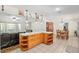 Open-concept living room area with tile floors, an island, and comfortable seating at 5390 Se 15Th Ct, Ocala, FL 34480