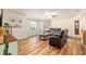 Cozy living room boasts hardwood floors, bright natural light, and comfortable seating furniture at 5390 Se 15Th Ct, Ocala, FL 34480