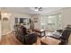 Inviting living room features wood floors, a ceiling fan, and a comfortable leather furniture set at 5390 Se 15Th Ct, Ocala, FL 34480