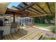 Outdoor bar area featuring a pergola, bar seating, and outdoor table and chairs with view of screened-in pool at 5390 Se 15Th Ct, Ocala, FL 34480