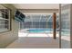 A covered patio overlooking a sparkling pool and fenced backyard at 5390 Se 15Th Ct, Ocala, FL 34480