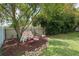 Backyard playset nestled in a shady area with a lush lawn and rock border for imaginative play at 5390 Se 15Th Ct, Ocala, FL 34480