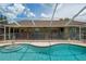 Gorgeous backyard pool with a safety fence and access to the lanai from the exterior of the home at 5390 Se 15Th Ct, Ocala, FL 34480
