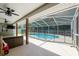 Enjoy a beautiful screened-in pool with safety fence from the covered patio at 5390 Se 15Th Ct, Ocala, FL 34480