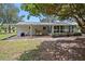 Wide view of the back of the property with its covered porch, furniture and outdoor cooking arrangement at 6495 Sw 109Th St, Ocala, FL 34476