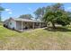 Lovely home with a big back yard that includes a covered porch, an outdoor furniture arrangement, and mature trees at 6495 Sw 109Th St, Ocala, FL 34476