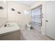 Bathroom with fish decor, shower and tub combo, and tiled floor at 6495 Sw 109Th St, Ocala, FL 34476