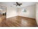 A light-filled room showcasing wood floors and a ceiling fan at 6495 Sw 109Th St, Ocala, FL 34476