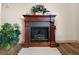 Close-up view of the fireplace featuring elegant wood trim, detailed embellishments, and marble hearth at 6495 Sw 109Th St, Ocala, FL 34476