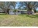 Charming home exterior with mature trees, blue shutters and a well-maintained lawn at 6495 Sw 109Th St, Ocala, FL 34476