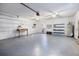 Clean, spacious two-car garage featuring ample storage space, work bench, ceiling fans, and access to the house at 6495 Sw 109Th St, Ocala, FL 34476