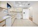 Well-lit kitchen featuring white appliances and cabinetry at 6495 Sw 109Th St, Ocala, FL 34476