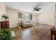 Open-concept living room with hardwood floors, fireplace, and neutral-toned furniture at 6495 Sw 109Th St, Ocala, FL 34476