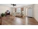 Bright living room with hardwood floors, a cozy fireplace, and a comfortable seating area at 6495 Sw 109Th St, Ocala, FL 34476