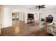 Spacious living room featuring hardwood floors, a ceiling fan, and an ornate fireplace at 6495 Sw 109Th St, Ocala, FL 34476