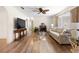 Well-lit living room showcasing hardwood floors, fireplace, and neutral-toned furniture at 6495 Sw 109Th St, Ocala, FL 34476