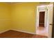 Cozy bedroom with hardwood floors and a bright yellow wall, showcasing a calm aesthetic at 7 Pecan Drive Loop, Ocala, FL 34472