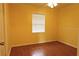Bright bedroom with hardwood floors, a window for natural light, and simple decor provides comfortable space at 7 Pecan Drive Loop, Ocala, FL 34472