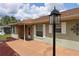 Close-up of the front entrance featuring a covered porch, a decorative front door, and an outdoor lantern at 7 Pecan Drive Loop, Ocala, FL 34472
