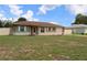 Charming single-story home with a well-maintained lawn, stone accents, and white shutters at 7 Pecan Drive Loop, Ocala, FL 34472