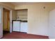 Laundry room with modern washer and dryer, shelving for storage, and easy access to the rest of the house at 7 Pecan Drive Loop, Ocala, FL 34472